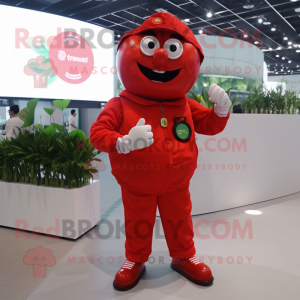 Red Tomato mascot costume character dressed with a Jumpsuit and Digital watches