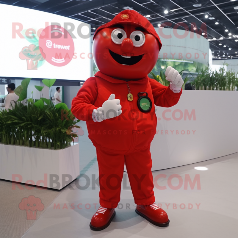 Red Tomato mascot costume character dressed with a Jumpsuit and Digital watches