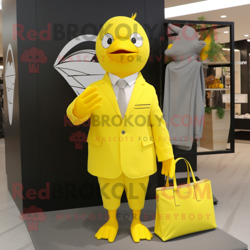 Lemon Yellow Dove mascot costume character dressed with a Suit and Tote bags Lemon Yellow Dove mascot costume character dressed with a Suit and Tote bags