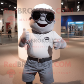 Gray Cyclops mascot costume character dressed with a Polo Shirt and Sunglasses