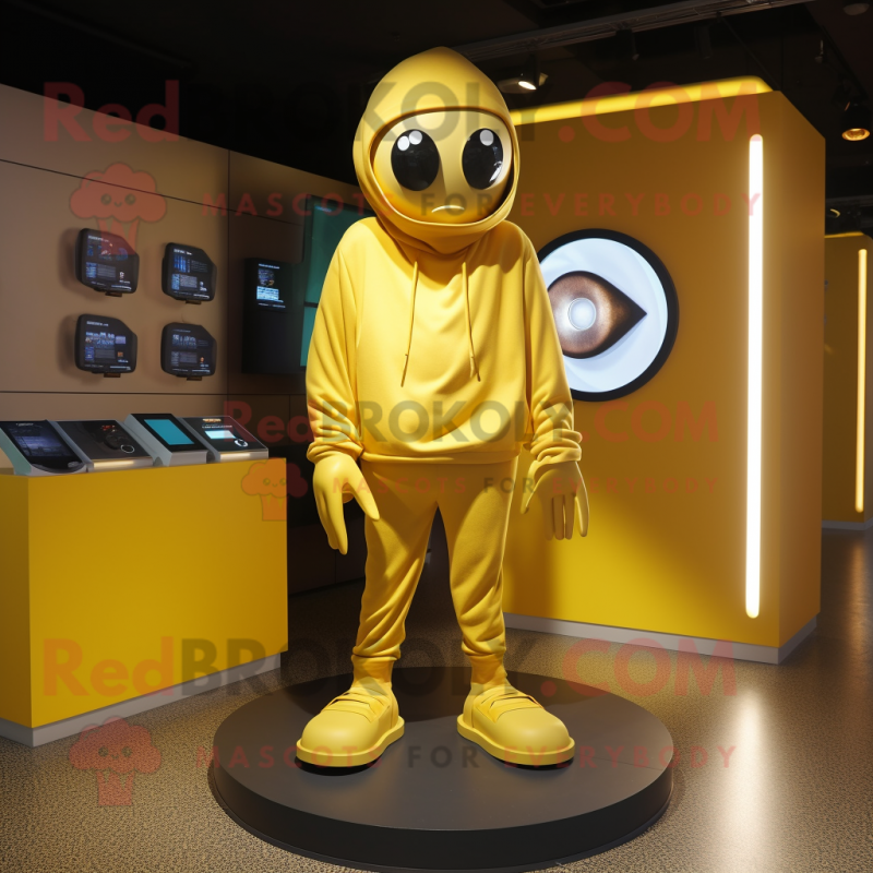 Gold Cyclops mascot costume character dressed with a Hoodie and Shoe clips Gold Cyclops mascot costume character dressed with a Hoodie and Shoe clips