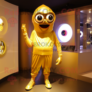 Gold Cyclops mascot costume character dressed with a Hoodie and Shoe clips