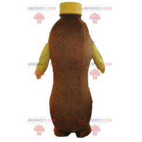 Mascote marrom e garrafa amarela de bebida de chocolate -