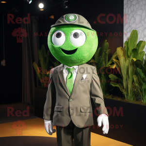 Olive Golf Ball mascot costume character dressed with a Suit Jacket and Rings