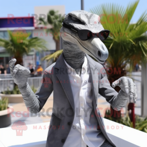 Gray Velociraptor mascot costume character dressed with Blazer and Sunglasses