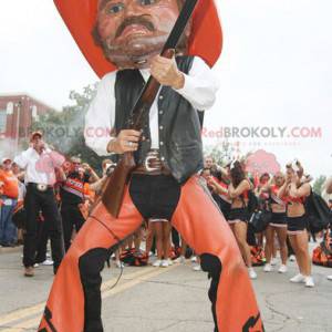 Cowboymascotte in traditionele oranje en zwarte kleding -