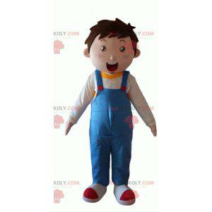 Kleine jongensmascotte die blauwe overall draagt -