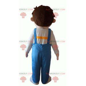 Kleine jongensmascotte die blauwe overall draagt -