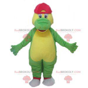 Green and yellow crocodile mascot with a red cap -