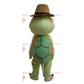Groen en oranje schildpadmascotte met een cowboyhoed -