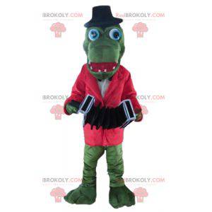 Zelený krokodýlí maskot s červenou bundou a akordeonem -
