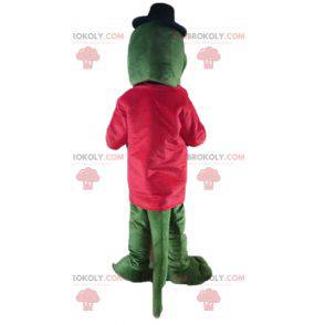 Zielona maskotka krokodyl z czerwoną kurtką i akordeonem -