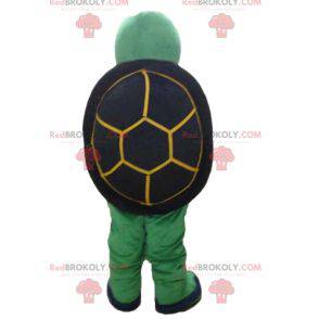 Amable y sonriente mascota tortuga verde y negra amarilla -
