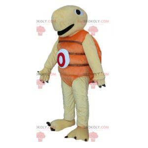 Mascota tortuga beige y naranja muy jovial y sonriente -