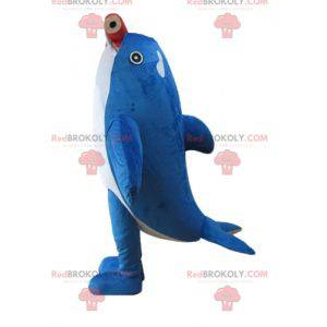 Mascote da baleia assassina azul e branca com um lápis gigante