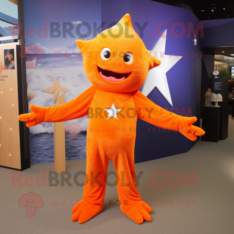 Orange Starfish mascot costume character dressed with a Long Sleeve Tee and Lapel pins