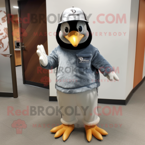 Gray Penguin mascot costume character dressed with a Jeans and Hat pins