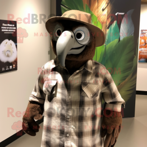 Brown Vulture mascot costume character dressed with a Flannel Shirt and Hat pins