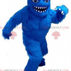 Mascote do yeti todo peludo e azul com dentes grandes -