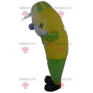 Reusachtige mascotte van gele en groene maïskolf -