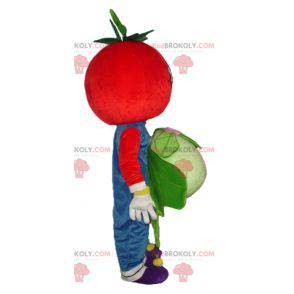 Sorridente mascotte pomodoro rosso con un cavolfiore -