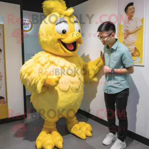 Yellow Fried Chicken mascot costume character dressed with a Chinos and Watches