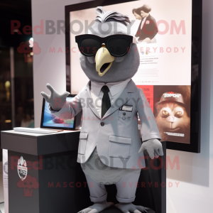 Gray Pigeon mascot costume character dressed with a Blazer and Sunglasses