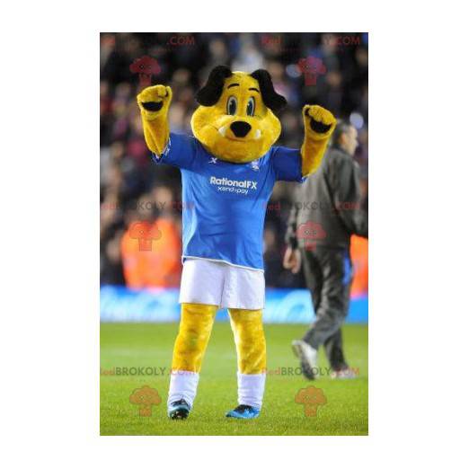 Mascote cachorro amarelo e preto em roupas esportivas -