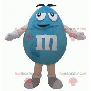 Mollige en grappige gigantische blauwe M & M-mascotte -