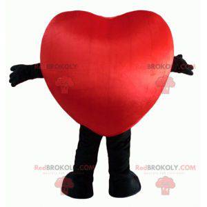 Mascota gigante de corazón rojo y negro y sonriendo -