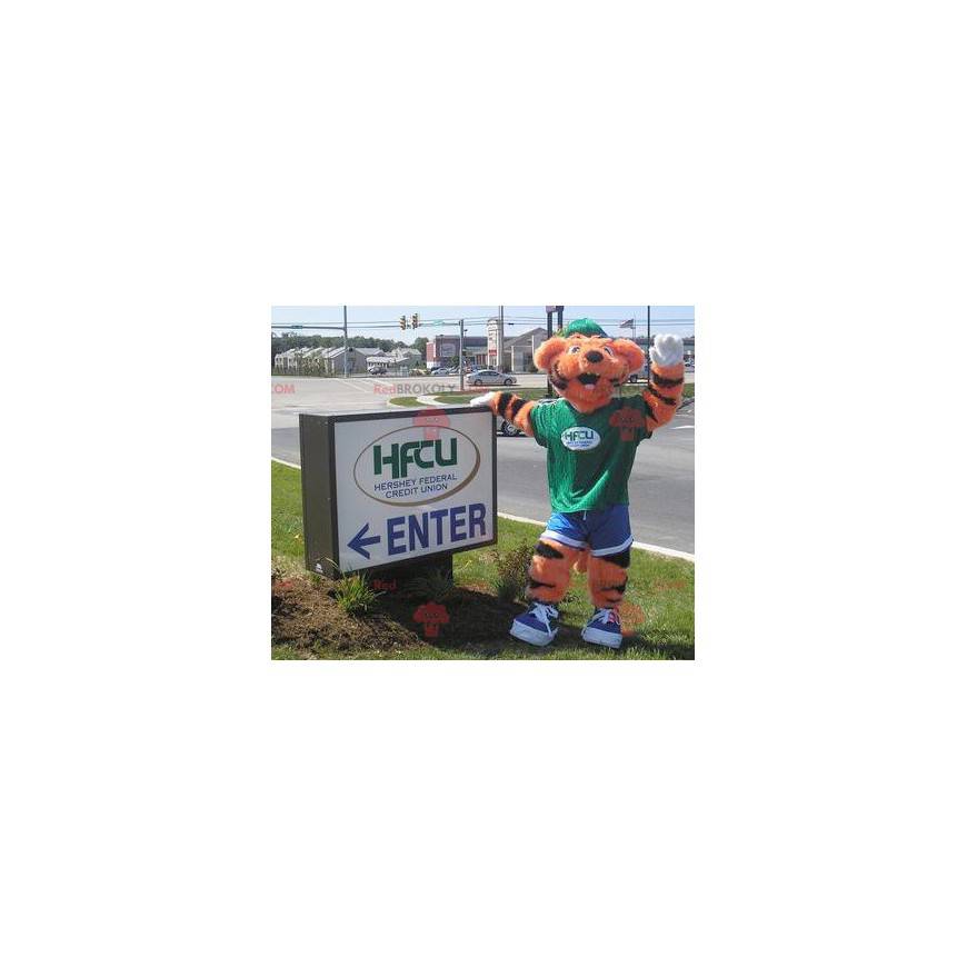 Orange and black tiger mascot in green and blue outfit -