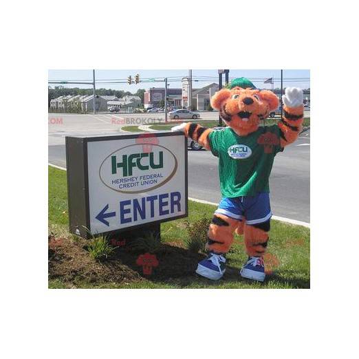 Orange and black tiger mascot in green and blue outfit -