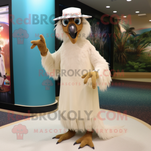 Cream Hawk mascot costume character dressed with a Maxi Dress and Caps