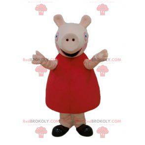 2 mascottes de cochons l'un en robe rouge l'autre en bleu -