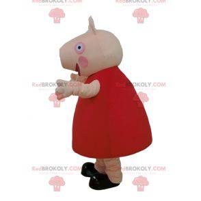2 pig mascots one in red dress the other in blue -
