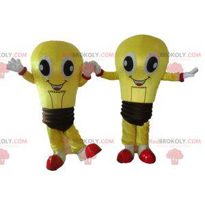 2 mascottes d'ampoules jaunes et marron très souriantes -