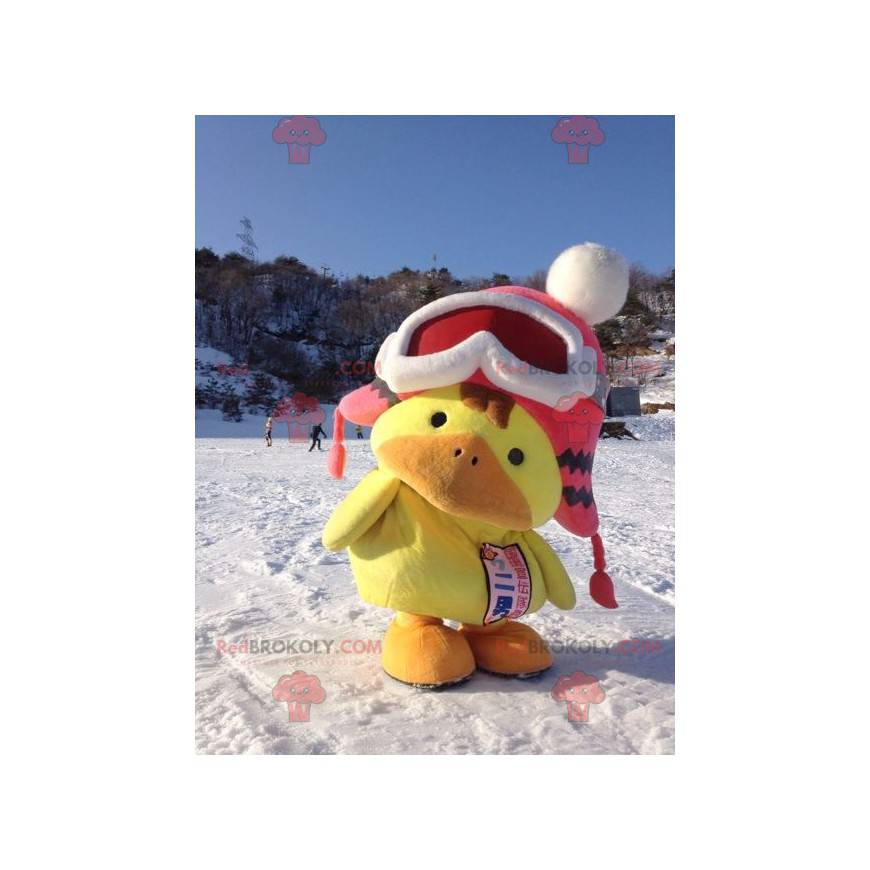 Mascote grande amarelo e laranja com um gorro de inverno -