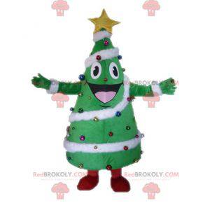 Mascotte gigante e sorridente dell'albero di Natale decorato -