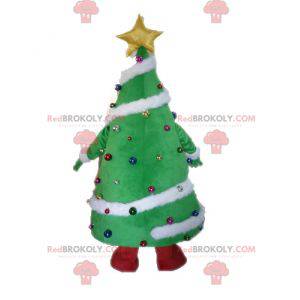 Mascotte gigante e sorridente dell'albero di Natale decorato -