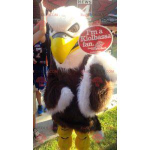 Mascot águila marrón, blanca y amarilla peluda e impresionante