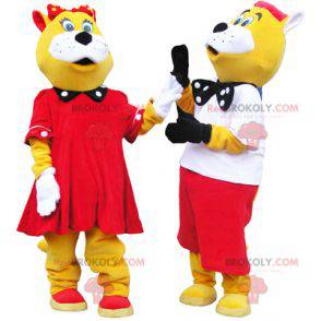 2 mascotes de gatos amarelos e brancos bem vestidos -