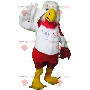 Mascote águia vermelha e branca em roupas esportivas -