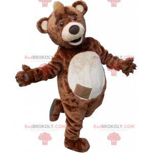 Mascota de oso de peluche marrón y beige con una cresta en la