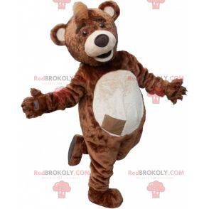 Mascota de oso de peluche marrón y beige con una cresta en la