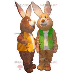 2 mascots of brown and white rabbits with colored vests -