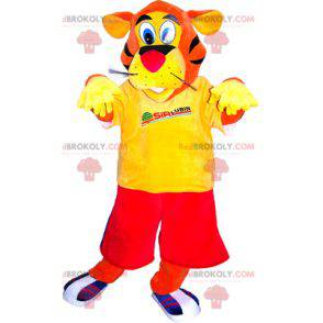 Mascotte de tigre orange habillé en rouge et jaune -