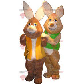 2 mascots of brown and white rabbits with colored vests -