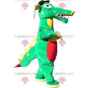 Mascotte de crocodile vert jaune et rouge avec un chapeau noir