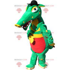 Mascote crocodilo verde, amarelo e vermelho com um chapéu preto