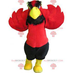 Mascote águia vermelha e amarela com calção preto -